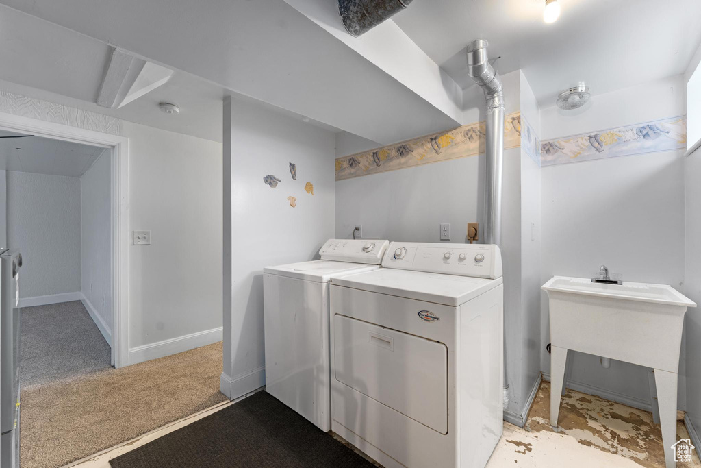 Washroom featuring independent washer and dryer and light carpet