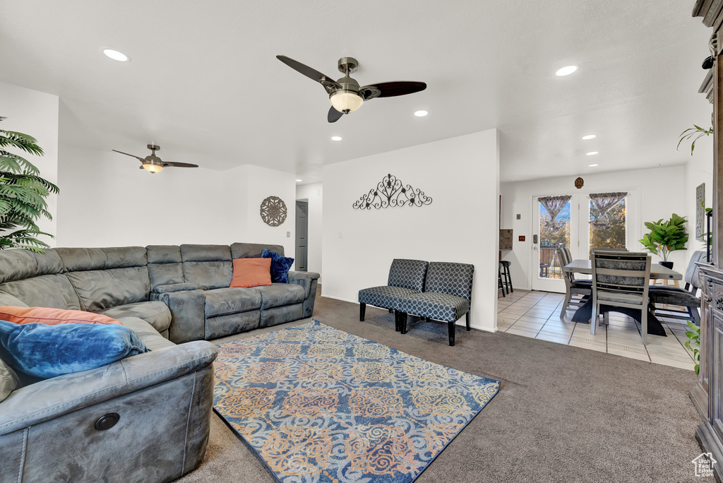 Living room featuring ceiling fan and light colored carpet