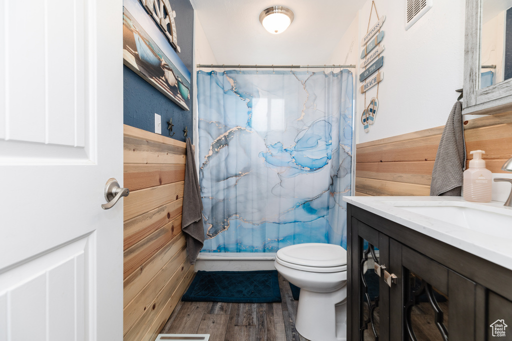 Bathroom featuring hardwood / wood-style floors, large vanity, and toilet