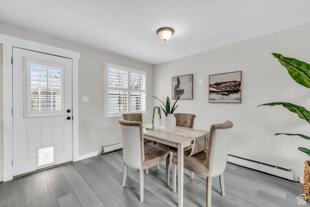 Dining area featuring a baseboard heating unit and light hardwood / wood-style floors