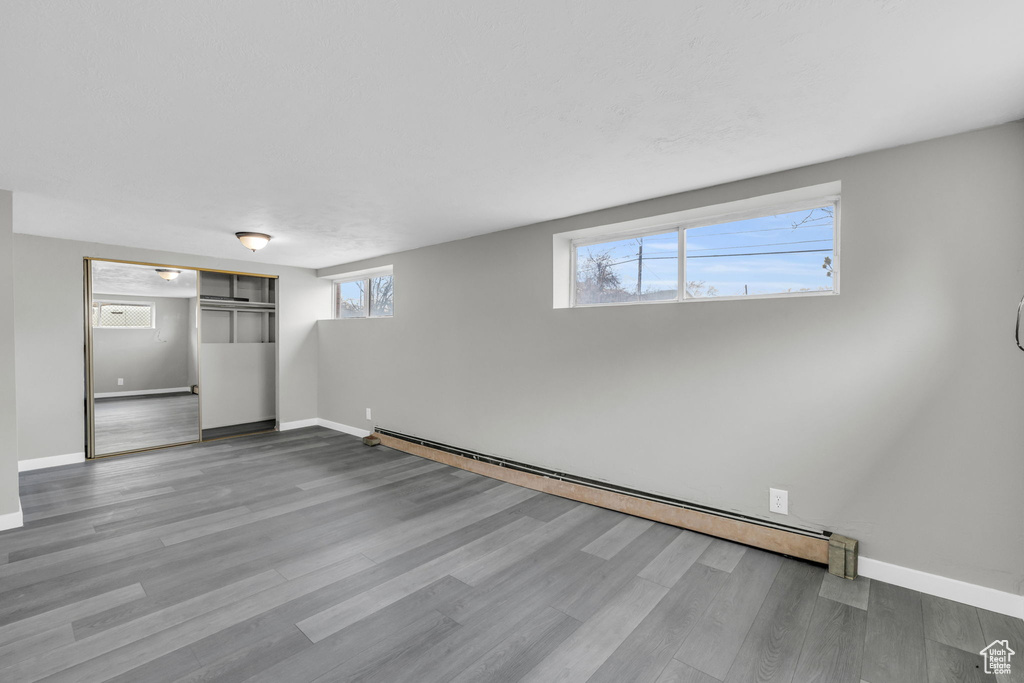Interior space featuring baseboard heating and hardwood / wood-style flooring