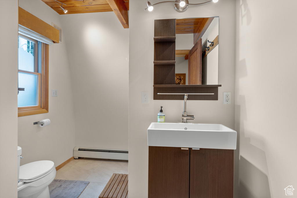 Bathroom with wood ceiling, vanity, tile flooring, a baseboard radiator, and toilet