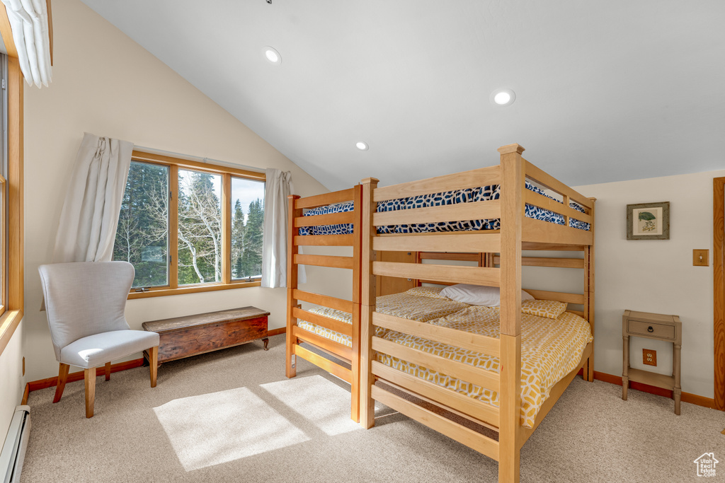 Bedroom featuring light colored carpet, vaulted ceiling, and baseboard heating