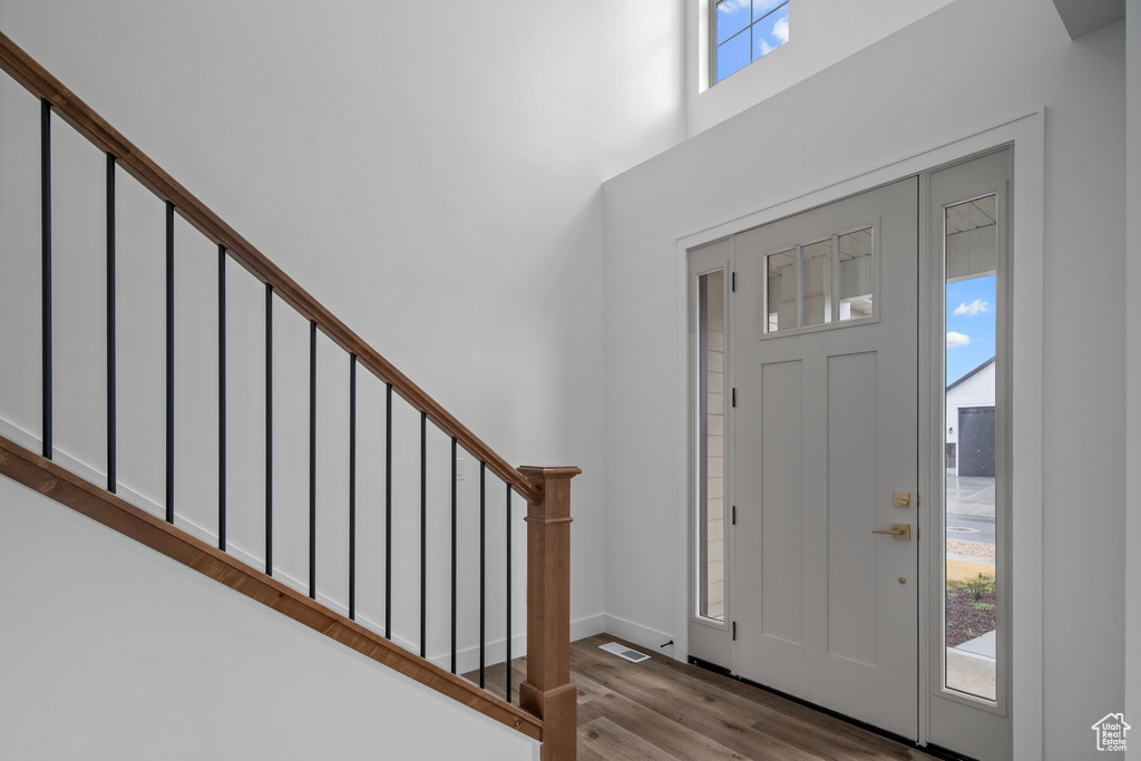 Entrance foyer with plenty of natural light and hardwood / wood-style flooring