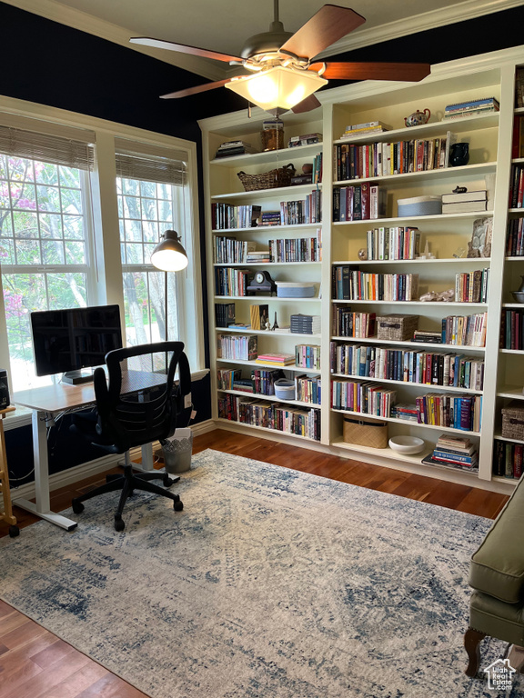 Office space featuring ornamental molding, dark wood-type flooring, and ceiling fan