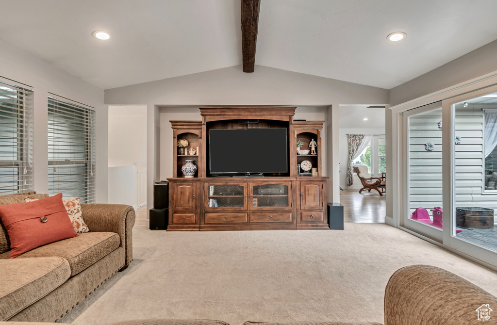 Living room featuring light carpet and vaulted ceiling with beams