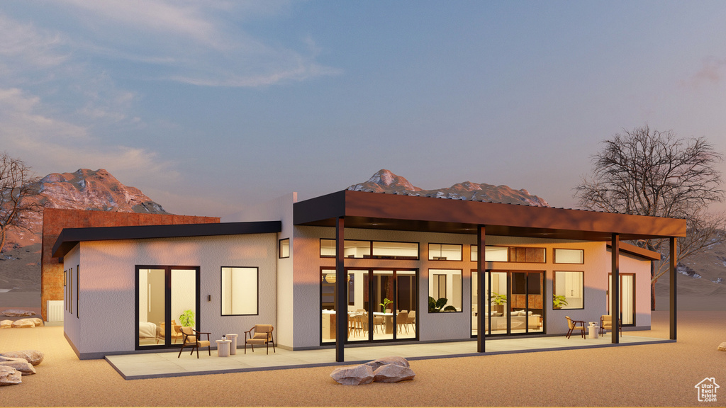 View of back of house at dusk