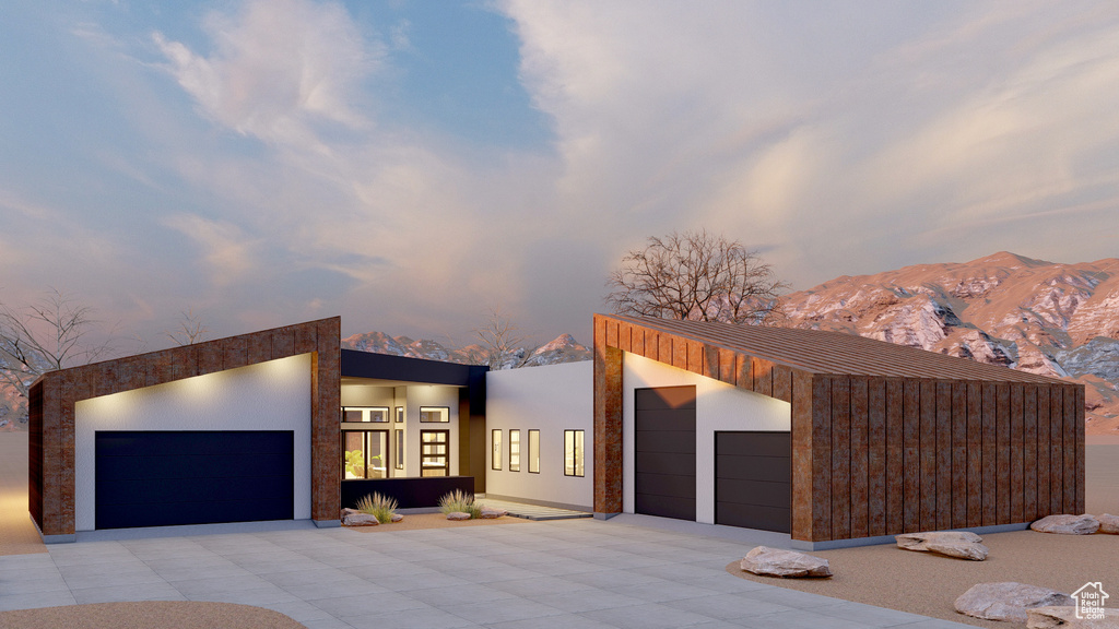 Contemporary home with driveway, a garage, and a mountain view