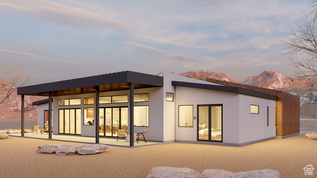 Rear view of house featuring a mountain view and a patio