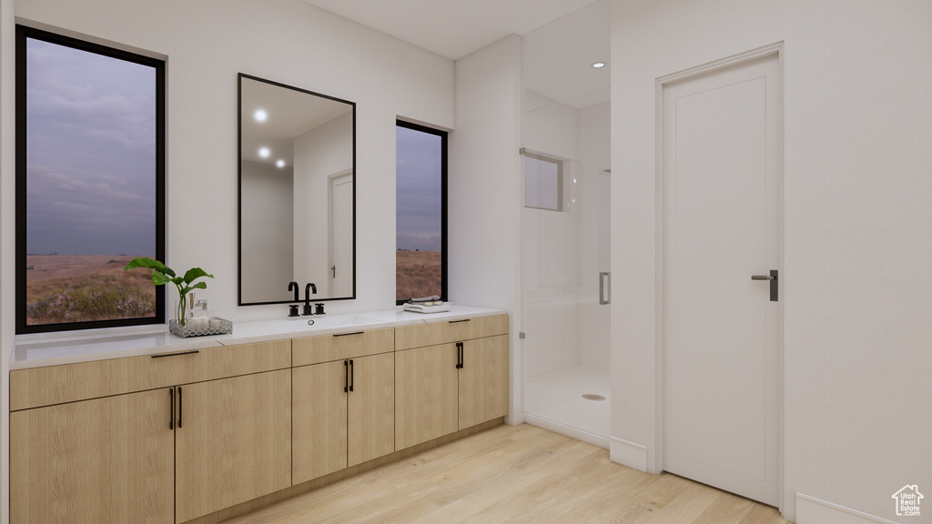 Bathroom with wood finished floors, a shower stall, vanity, and recessed lighting