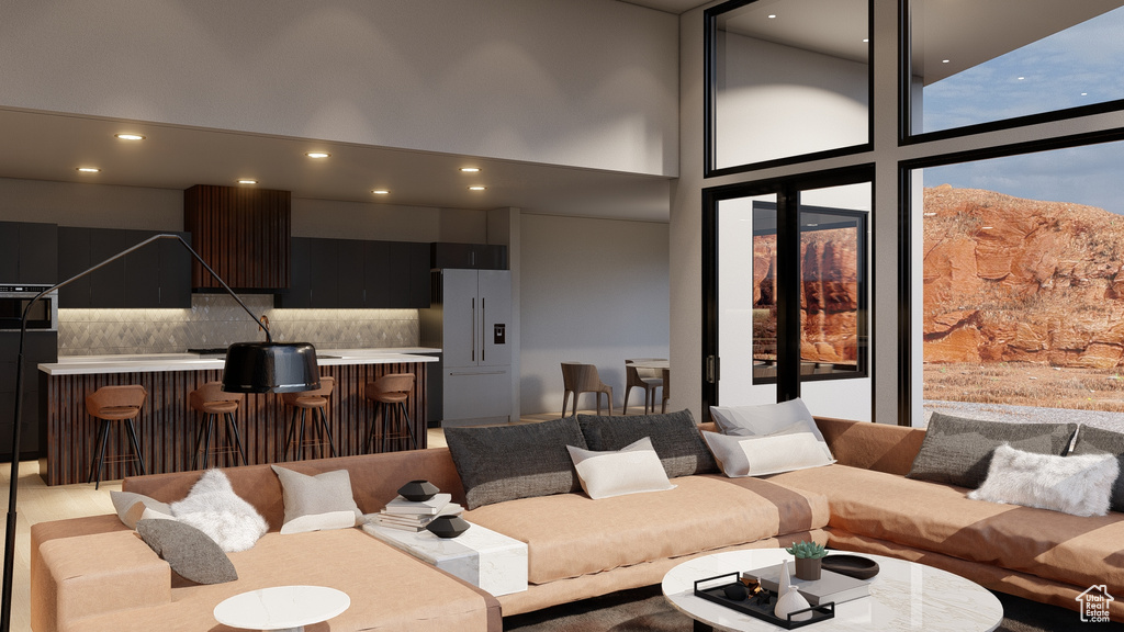 Living room featuring bar area, a high ceiling, and expansive windows
