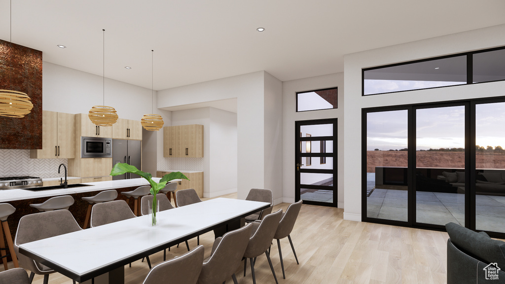 Dining space featuring light wood-style flooring and recessed lighting