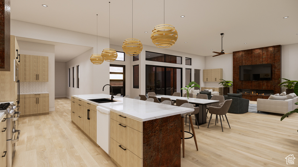 Kitchen featuring light brown cabinetry, light wood-style floors, modern cabinets, and recessed lighting