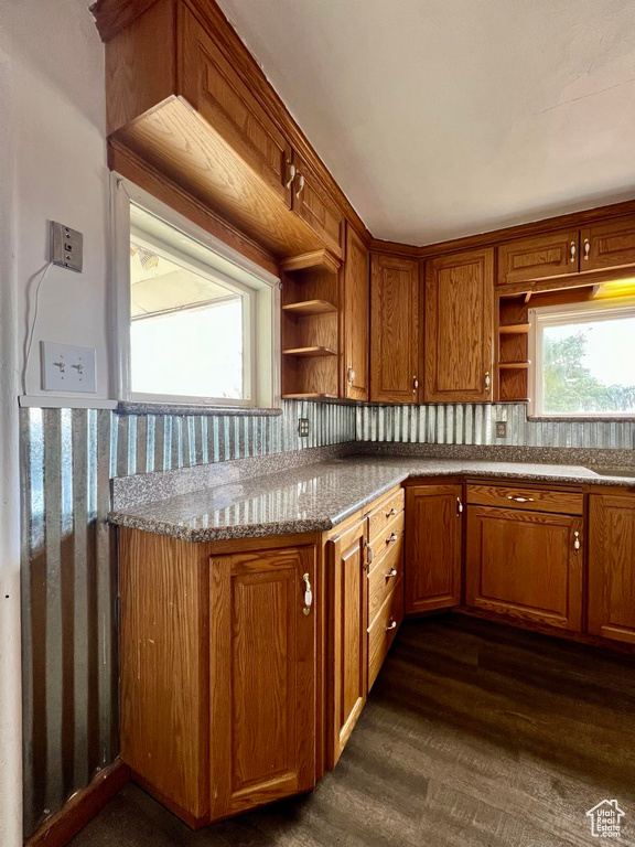 Kitchen featuring light stone countertops and dark hardwood / wood-style floors