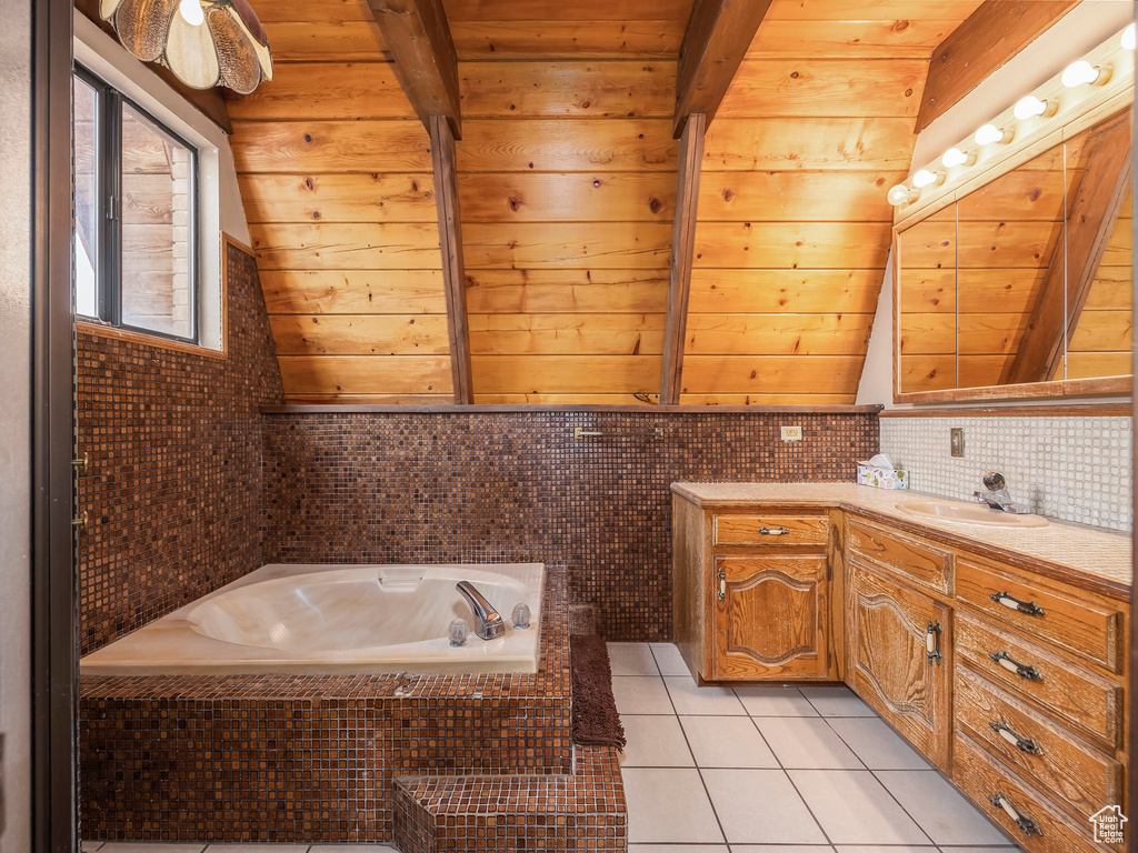 Bathroom with oversized vanity, wood ceiling, tasteful backsplash, a relaxing tiled bath, and tile floors