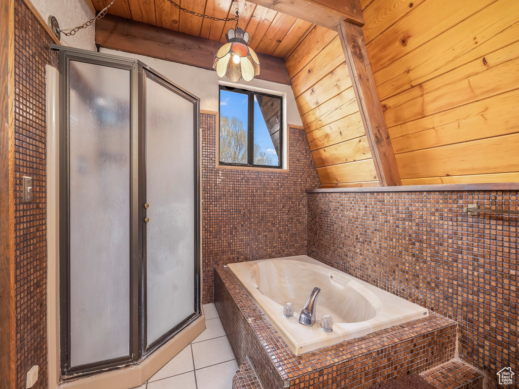 Bathroom featuring lofted ceiling with beams, wooden ceiling, independent shower and bath, and tile flooring