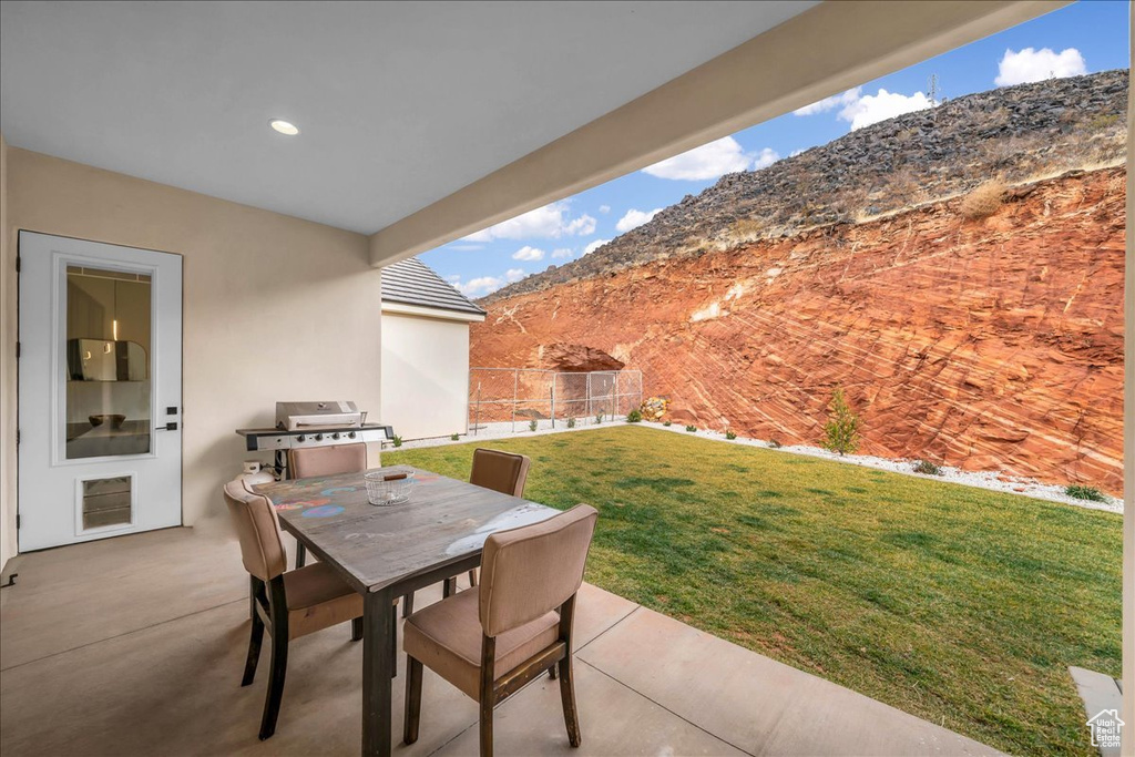 View of terrace with area for grilling and a mountain view