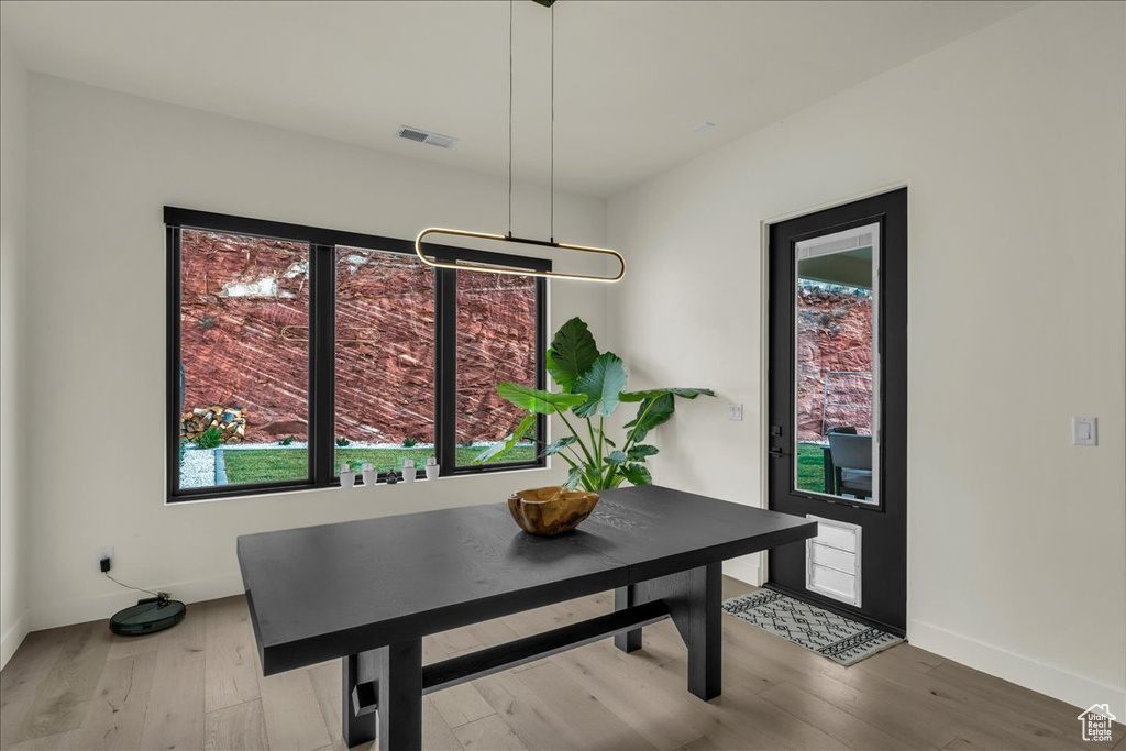 Dining space with light hardwood / wood-style floors