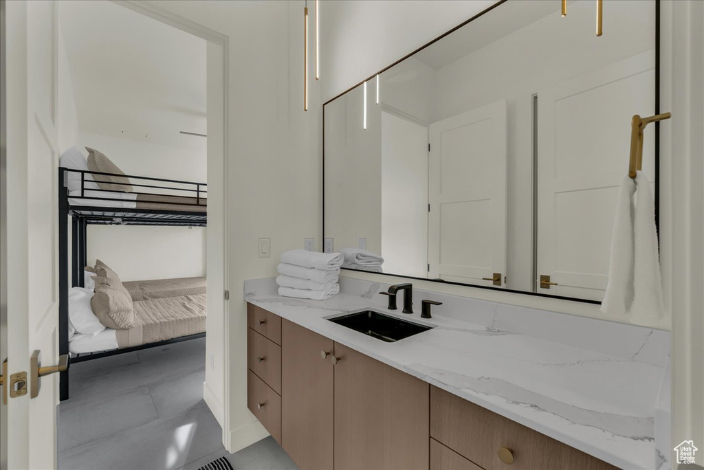 Bathroom featuring tile floors and vanity