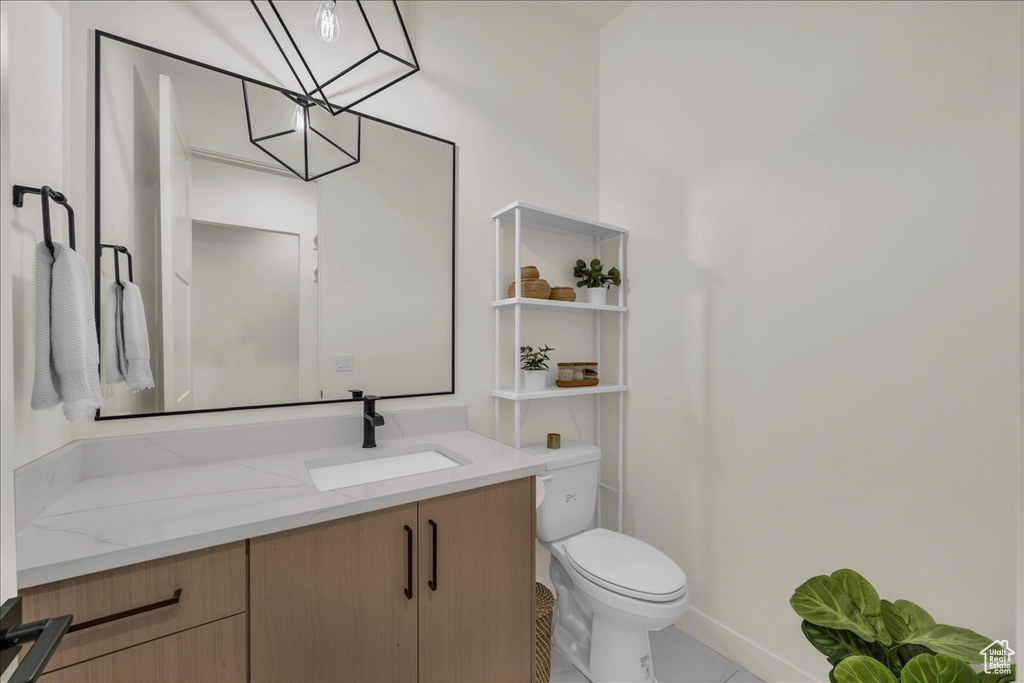 Bathroom featuring tile floors, toilet, and vanity