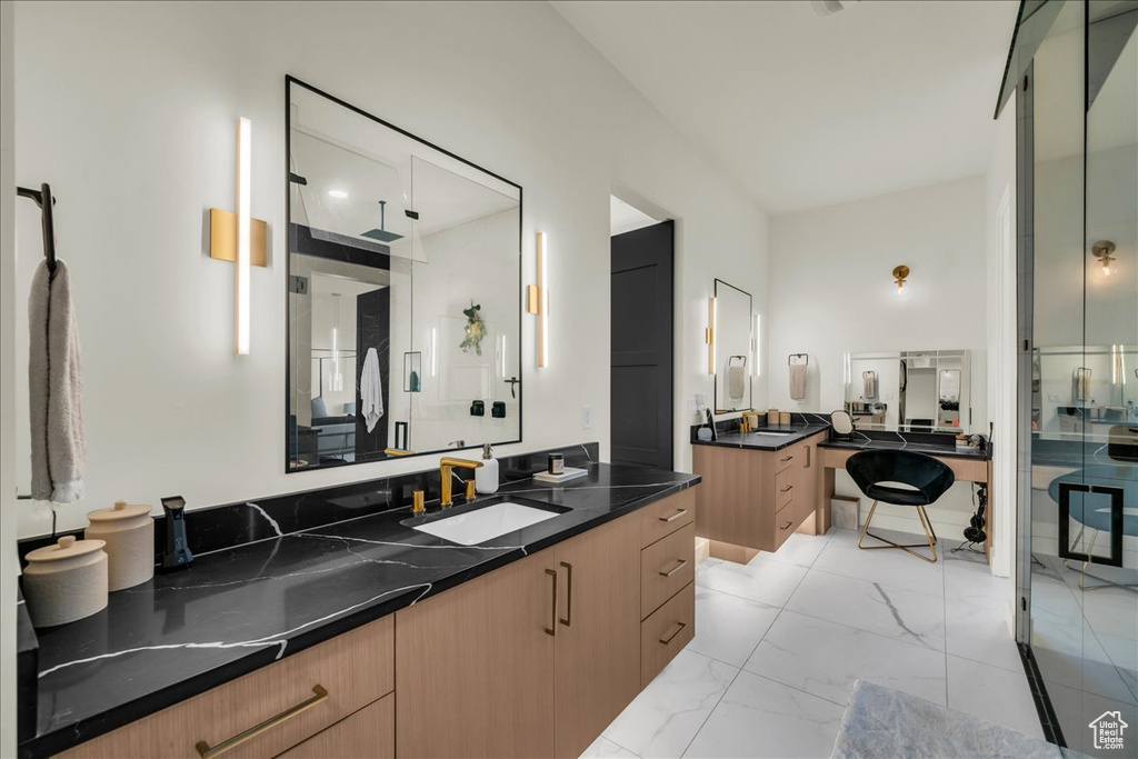 Bathroom featuring tile flooring, large vanity, and dual sinks