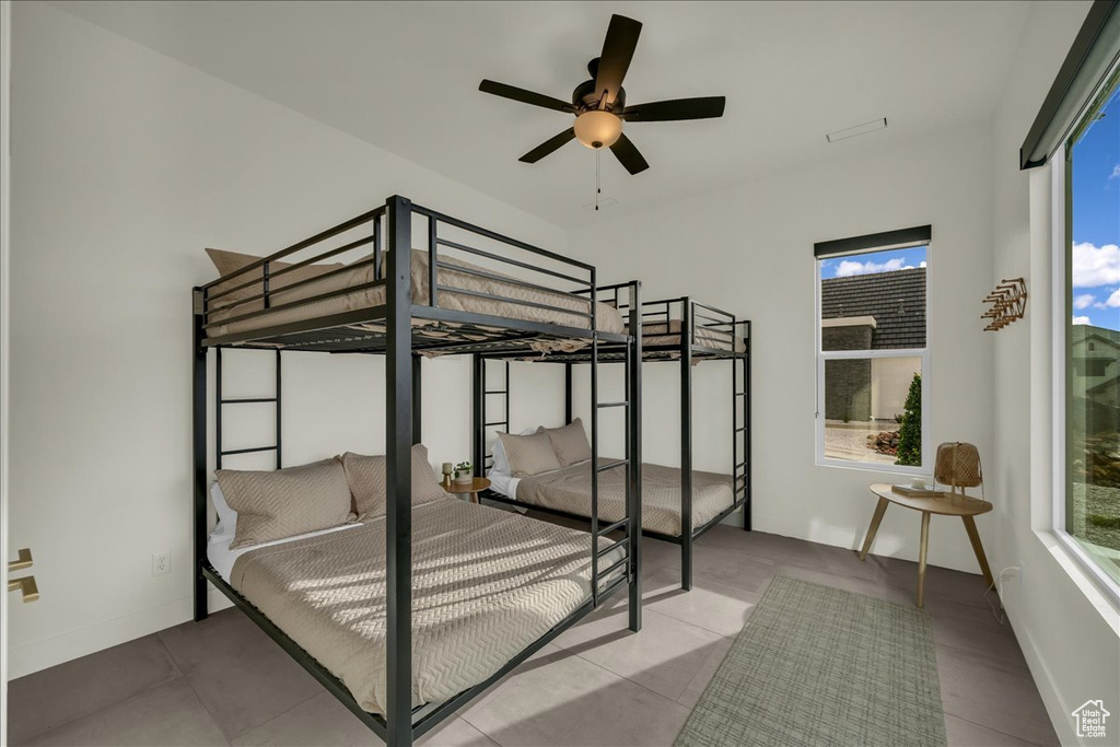 Bedroom featuring ceiling fan and light tile flooring