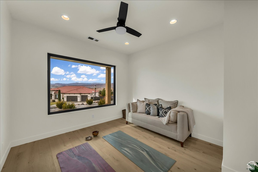 Interior space featuring ceiling fan and light wood-type flooring