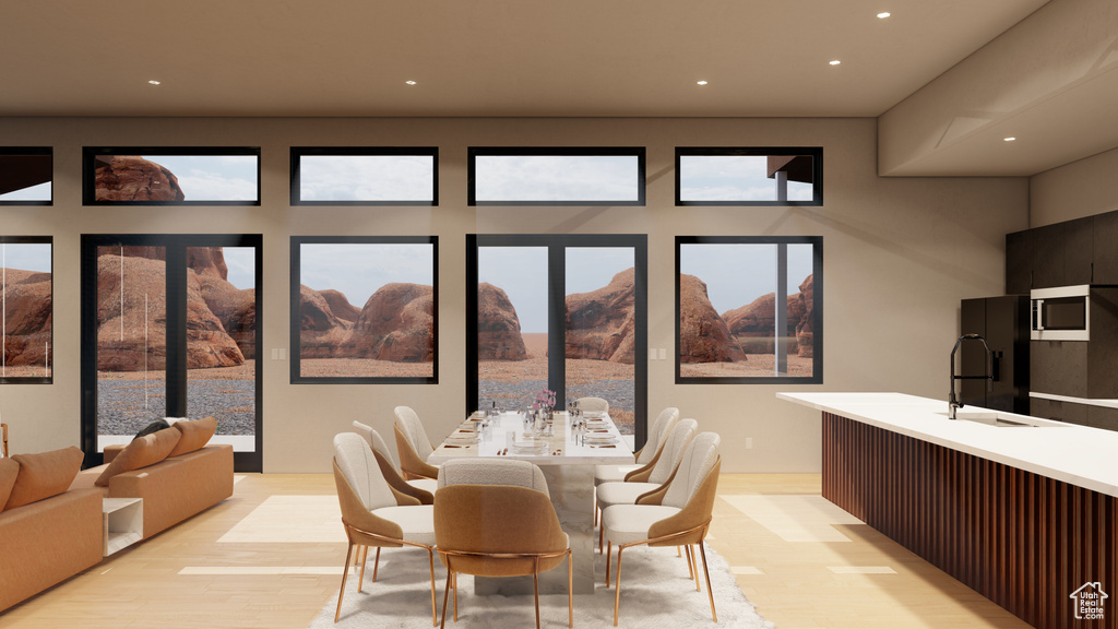 Dining area featuring a mountain view, sink, and light hardwood / wood-style flooring