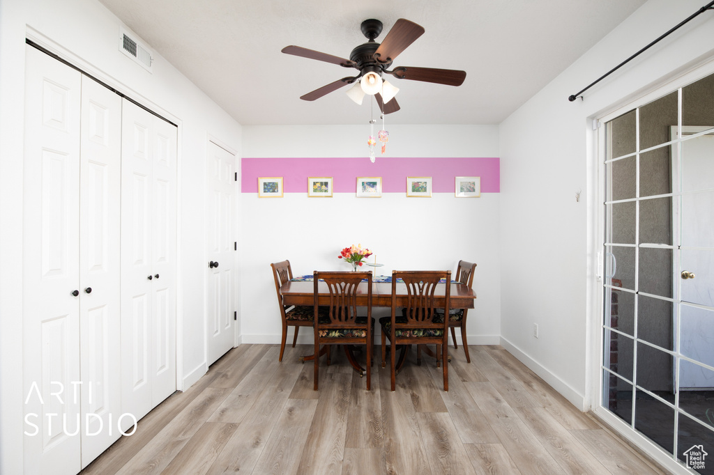 Dining area with light wood-type flooring and ceiling fan