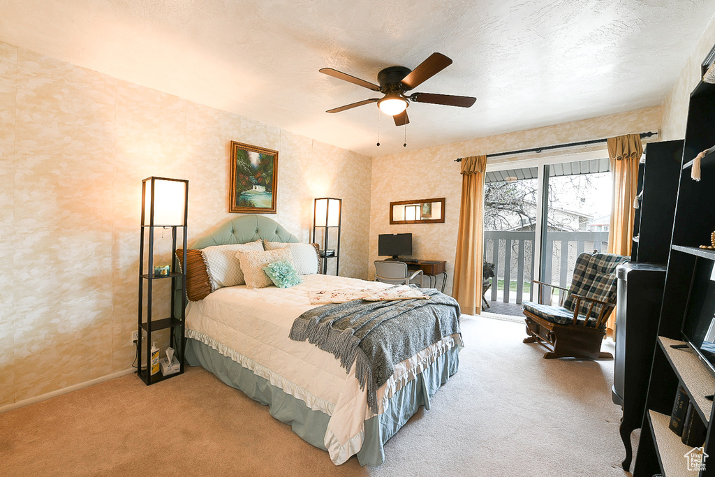 Bedroom featuring light carpet, access to exterior, and ceiling fan