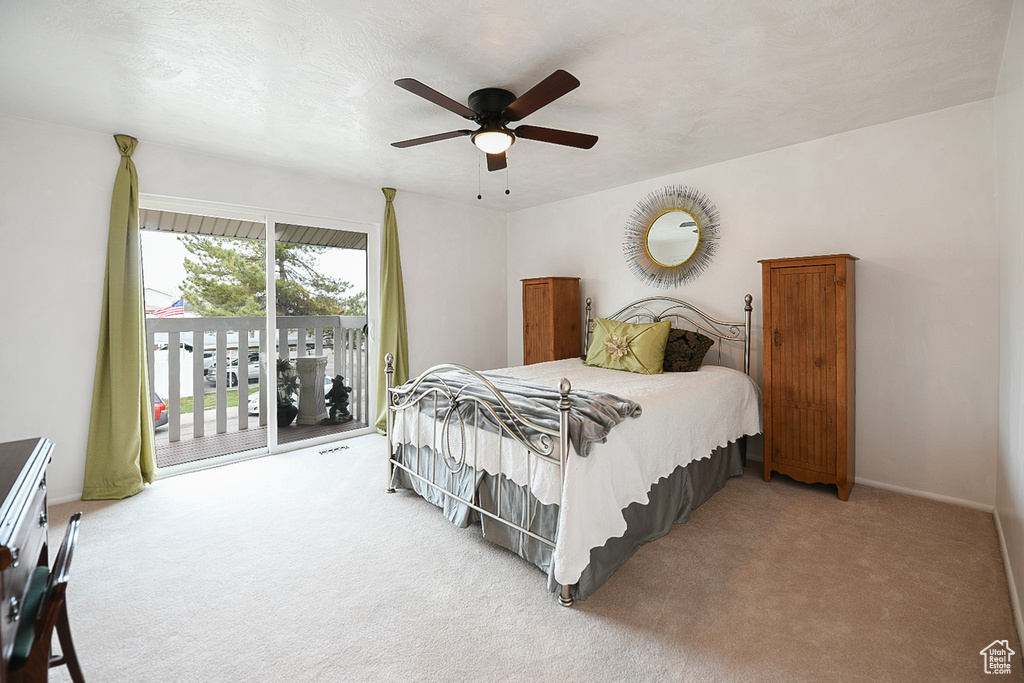 Bedroom featuring light carpet, ceiling fan, and access to outside