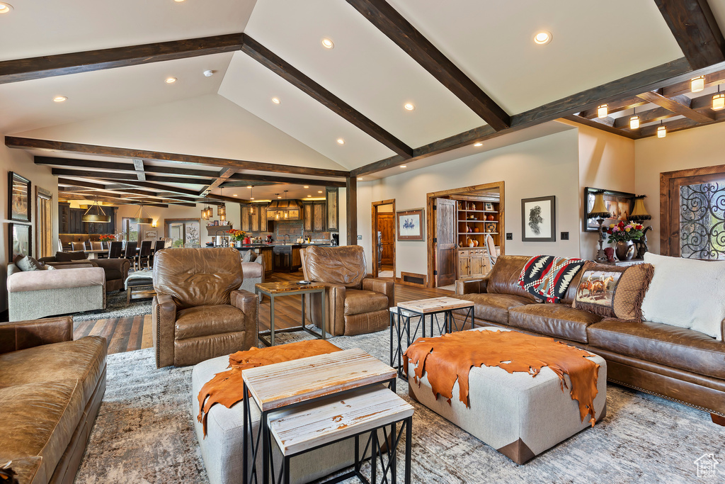 Living room featuring high vaulted ceiling and beam ceiling