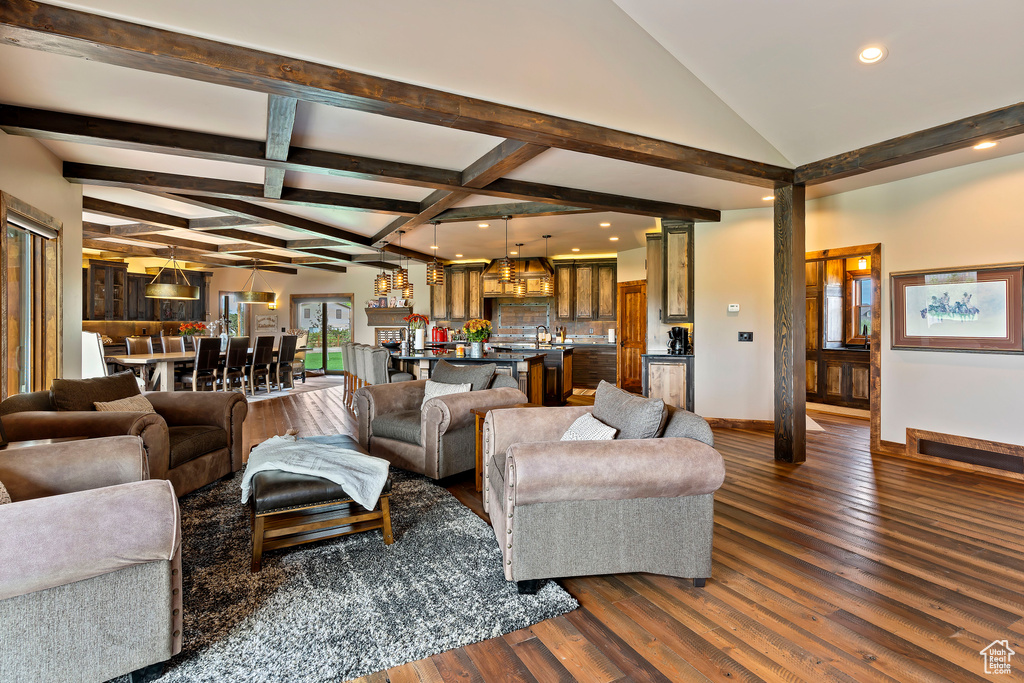 Living room featuring dark hardwood / wood-style floors and lofted ceiling with beams