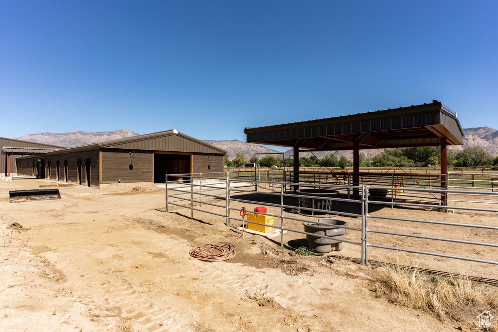 View of stable featuring an outdoor structure and a mountain view