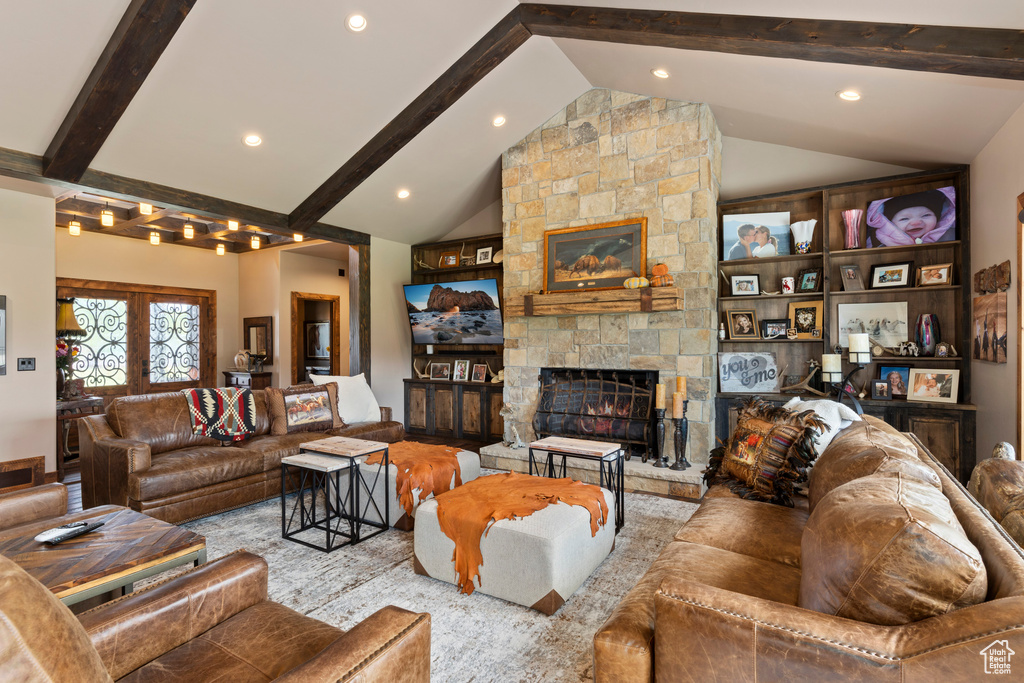 Living room with a fireplace, high vaulted ceiling, french doors, and beam ceiling