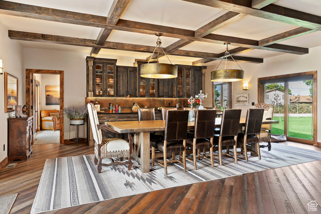 Dining room with coffered ceiling, dark wood-type flooring, and beamed ceiling