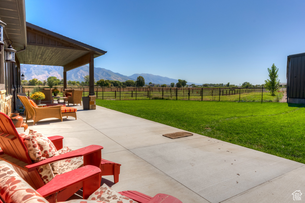 View of patio with an outdoor living space and a mountain view