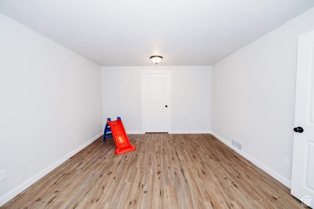 Rec room with light hardwood / wood-style flooring