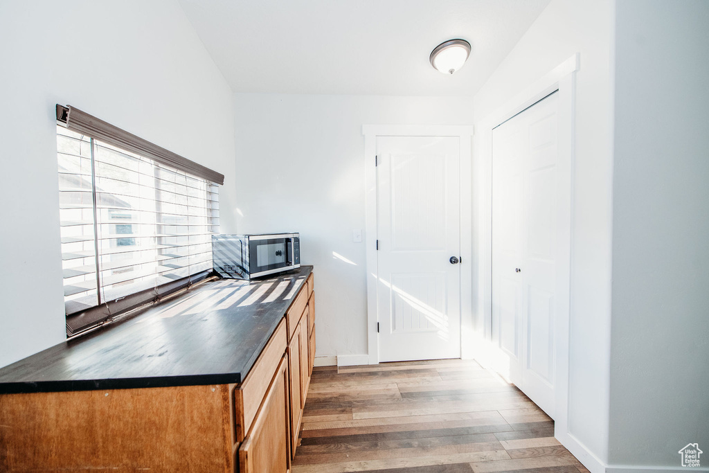 Kitchen with dark hardwood / wood-style floors