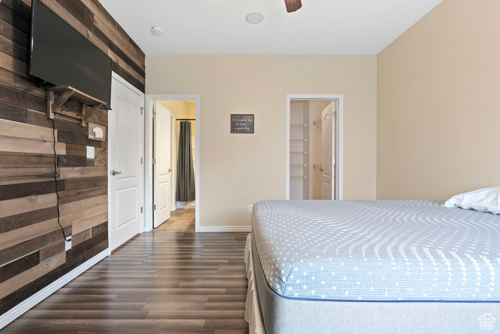 Bedroom featuring a spacious closet, a closet, and dark hardwood / wood-style flooring