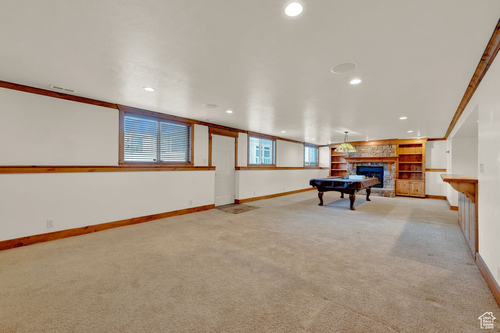 Playroom with built in features, ornamental molding, pool table, and light colored carpet