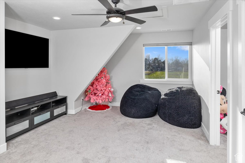Game room with light colored carpet and ceiling fan