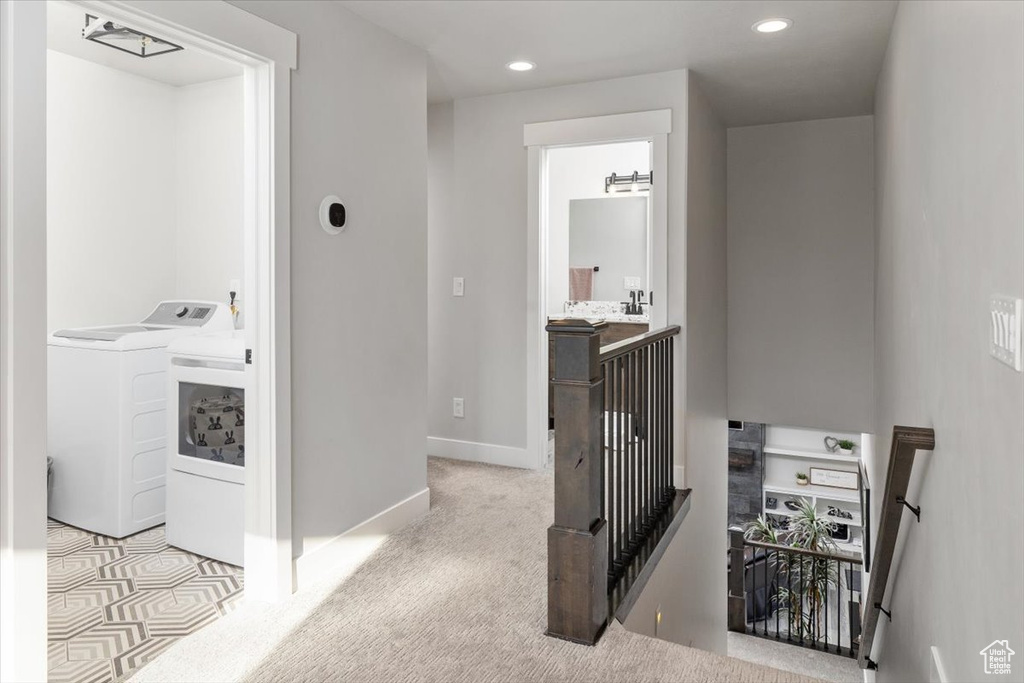 Corridor with separate washer and dryer and light tile floors
