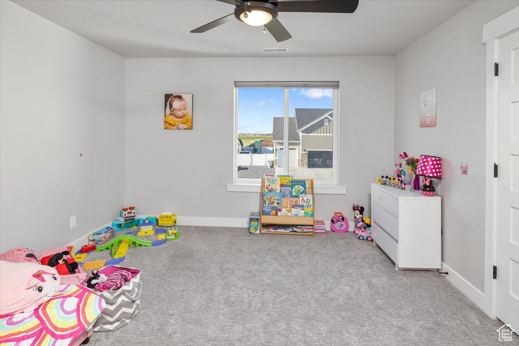 Playroom featuring ceiling fan and light colored carpet