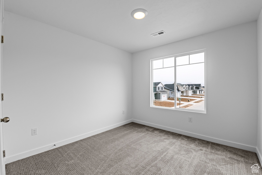 Unfurnished room featuring light colored carpet