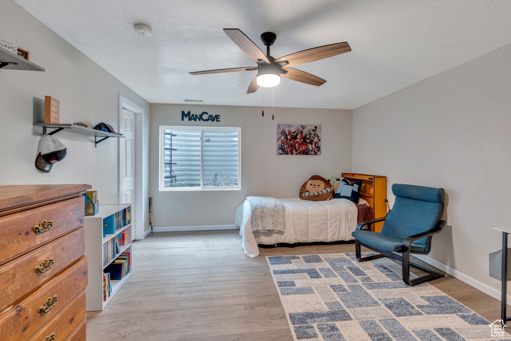 Bedroom with ceiling fan and light hardwood / wood-style flooring