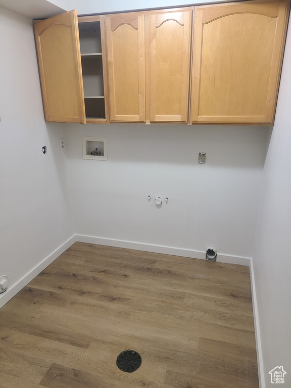 Laundry room with wood-type flooring, cabinets, hookup for a washing machine, and hookup for a gas dryer
