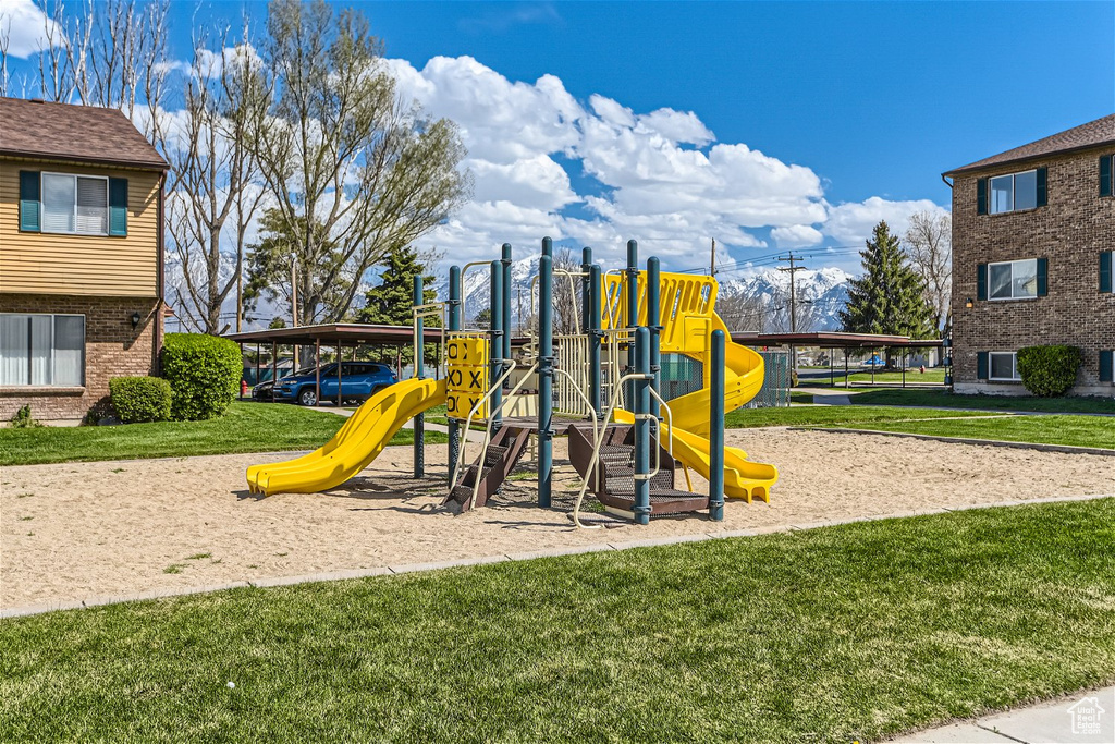 View of jungle gym featuring a lawn