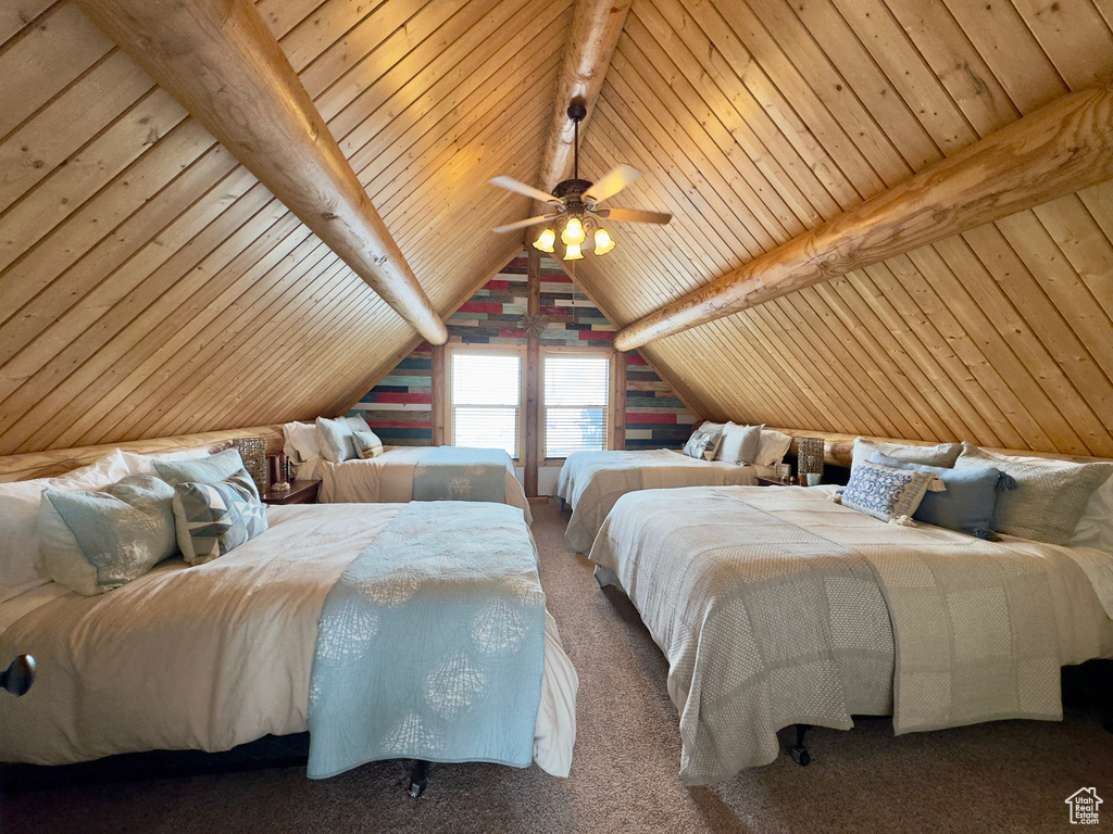 Carpeted bedroom featuring ceiling fan, vaulted ceiling with beams, and wood ceiling