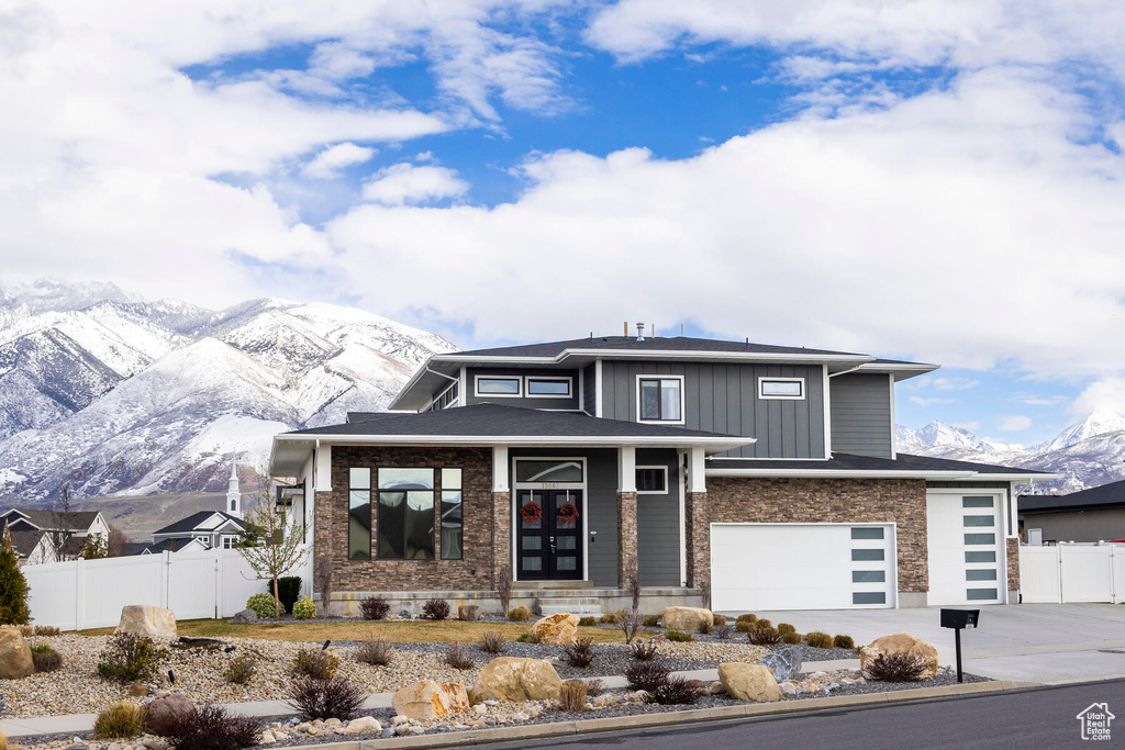 View of front facade with a mountain view and a garage